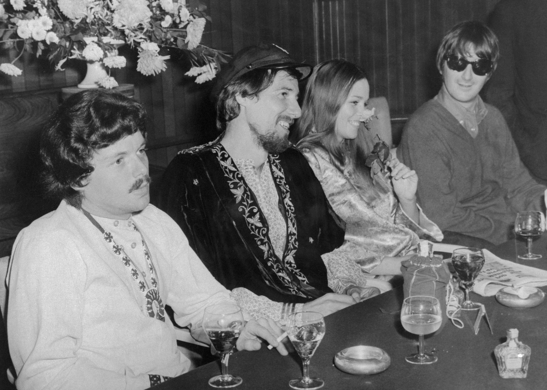 Members of The Mamas and the Papas and Scott McKenzie giving a press conference.