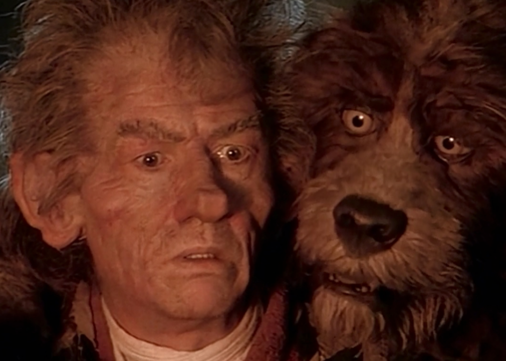John Hurt with Brian Henson in dog costume in a scene from ‘The Storyteller.’