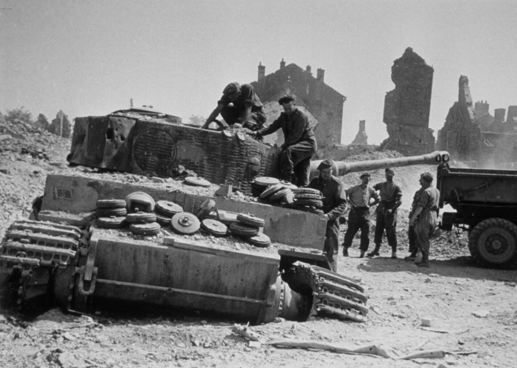 British engineers fill the wreck of a German tank with landmines in order to destroy it after the allies recaptured the village of Villers-Bocage in Normandy, France, in August 1944.