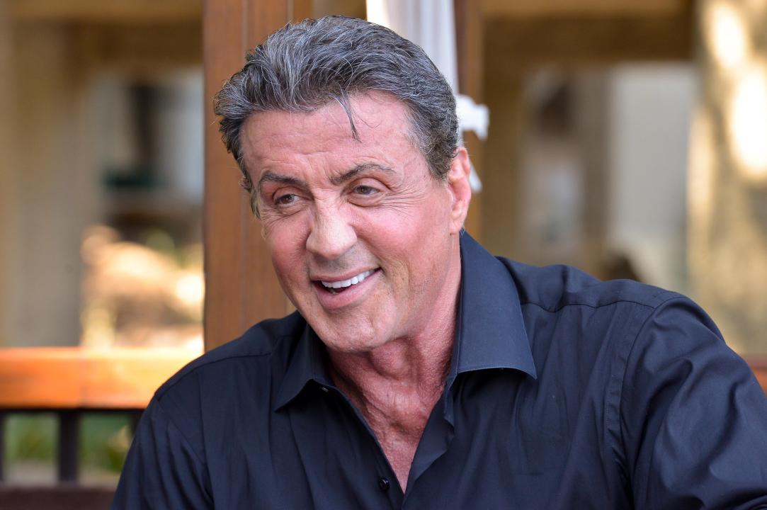 Sylvester Stallone smiles in an interview.