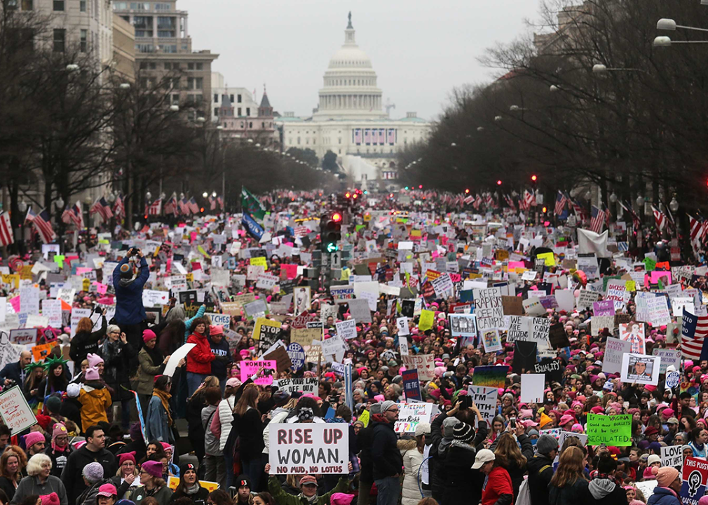 Protesters walk during the Women’s March on Washington with the U.S. Capitol in the background.