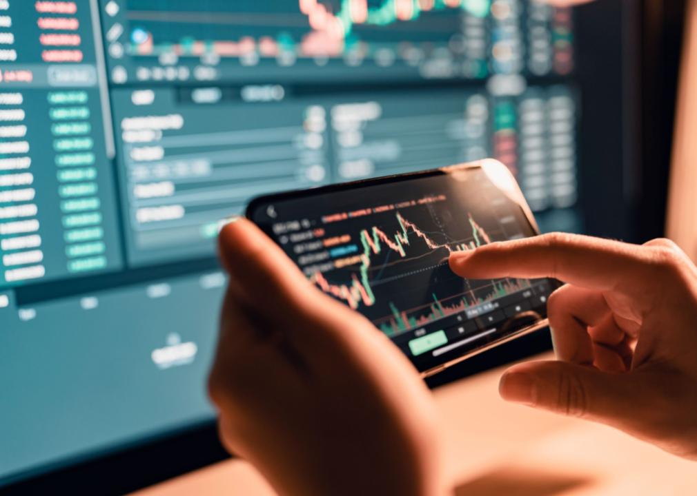 A woman checking Bitcoin price chart on a smartphone