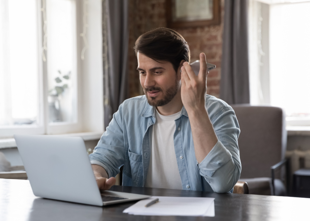 Man listening audio message on cellphone