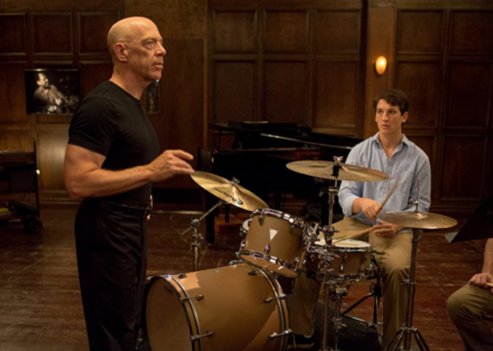 J.K. Simmons and Miles Teller talk over a drum set