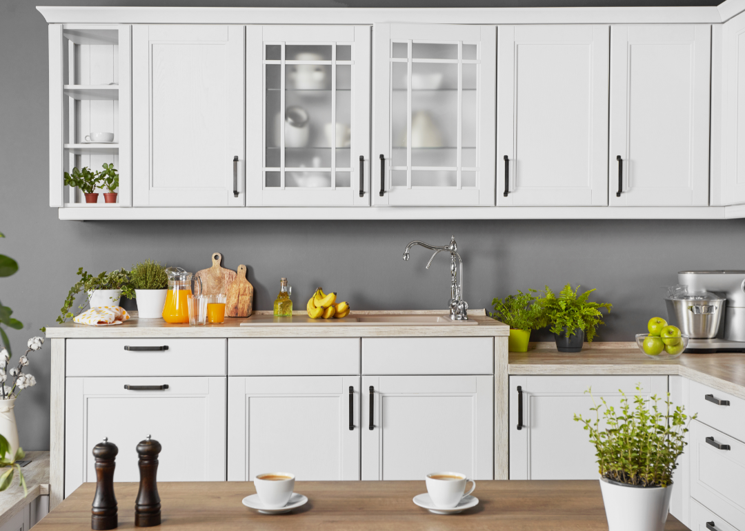 Bright kitchen with white cabinets and wood countertops