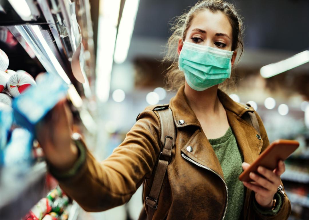 A woman in a protective mask shops in a market