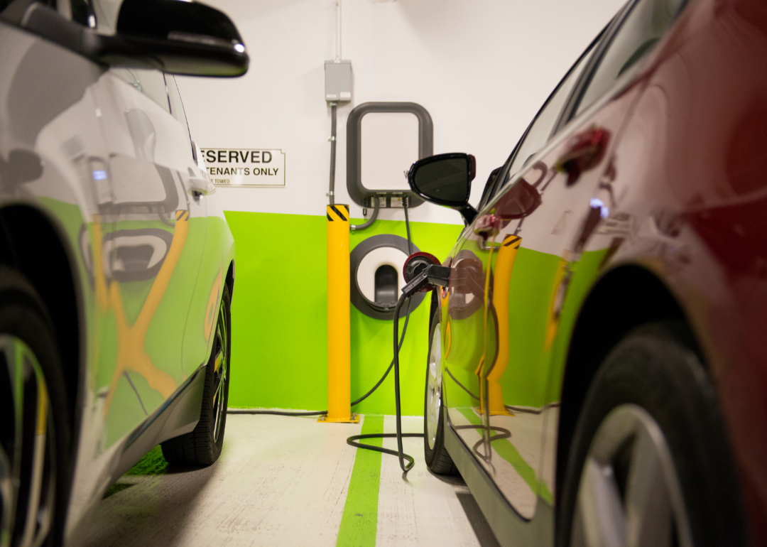 Two electric vehicles charge at an underground charging station