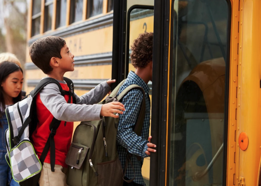 Kids boarding a school bus.