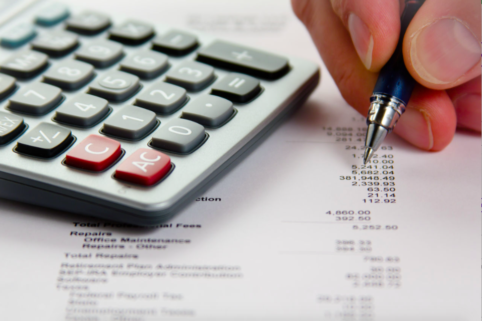 Picture of person working financials at a desk