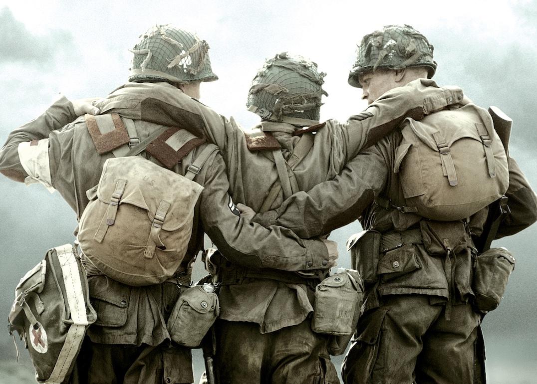 World War II soldiers stand with their backs to the camera in the HBO miniseries "Band of Brothers"