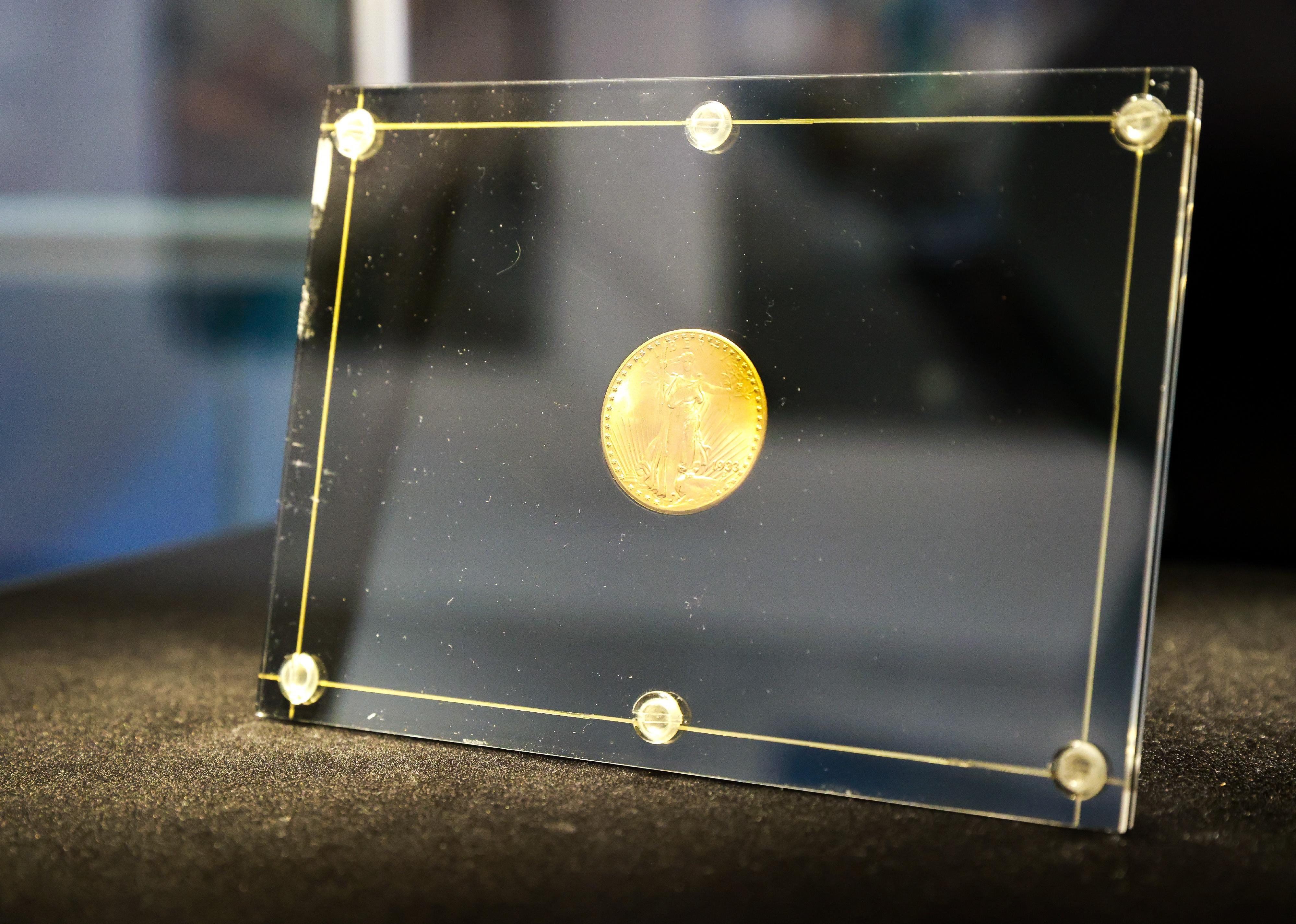 The only privately owned 1933 Double Eagle 20-dollar gold coin is on display in a black and glass case.