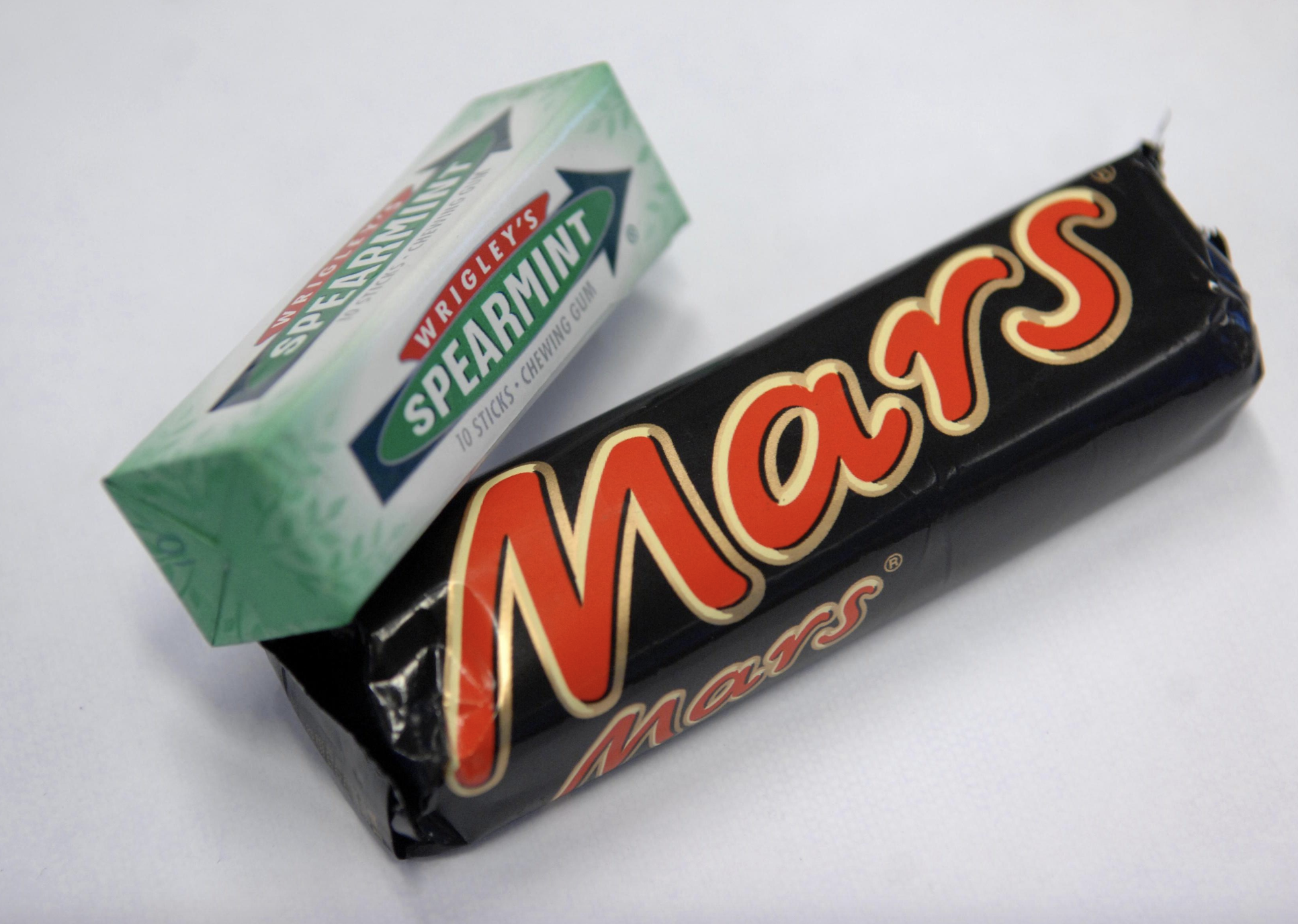 Wrigley's spearmint gum and a Mars bar lie side by side.