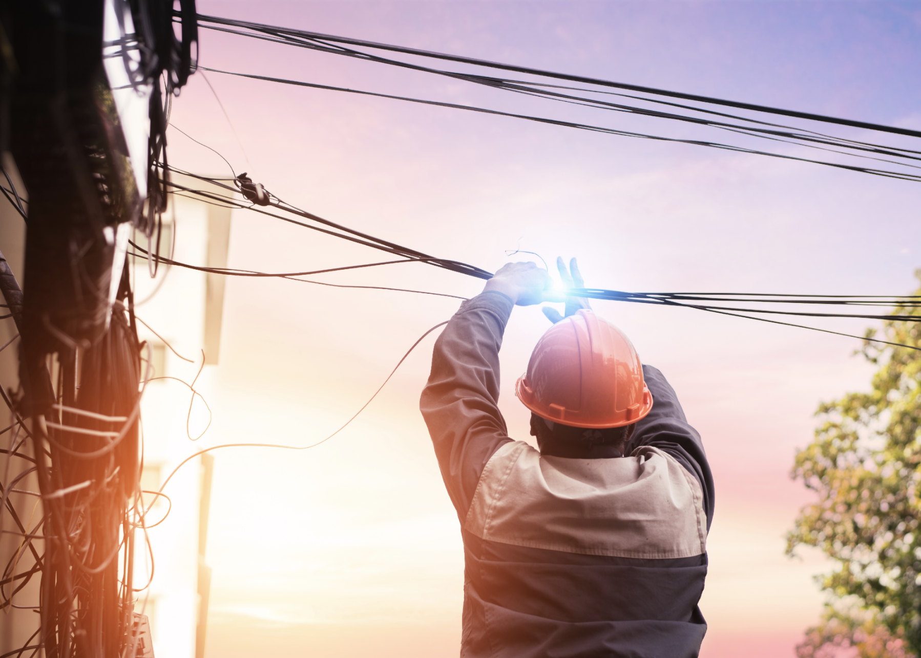 Electrical technician cutting cable.