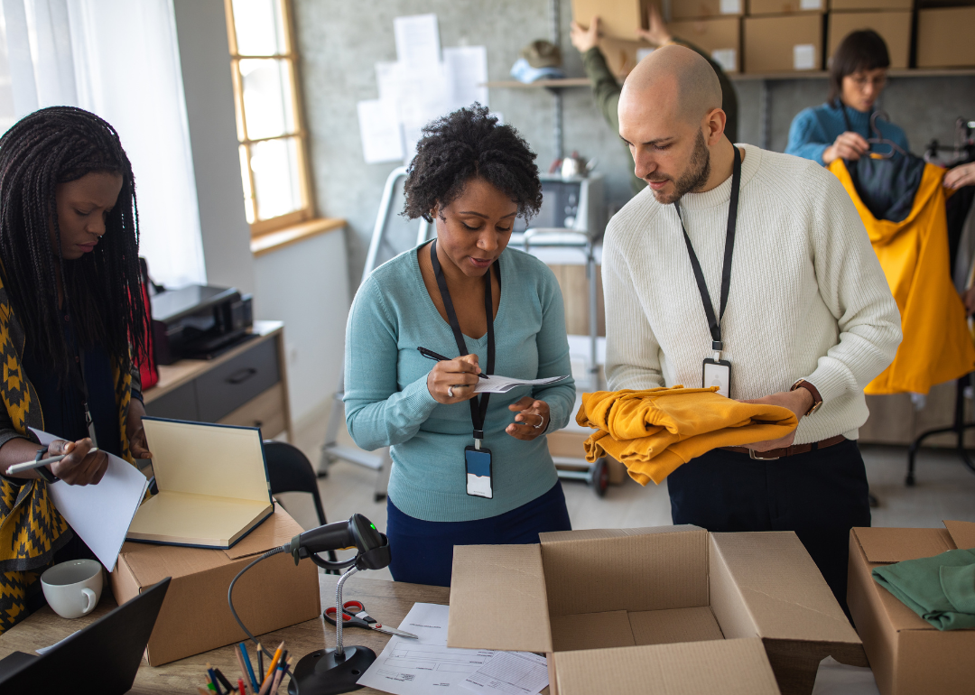 E-commerce workers talk as they fulfill retail orders. 