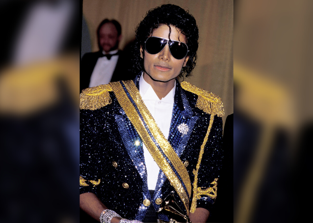 Michael Jackson in a gold-and-blue sequined blazer and sunglasses.