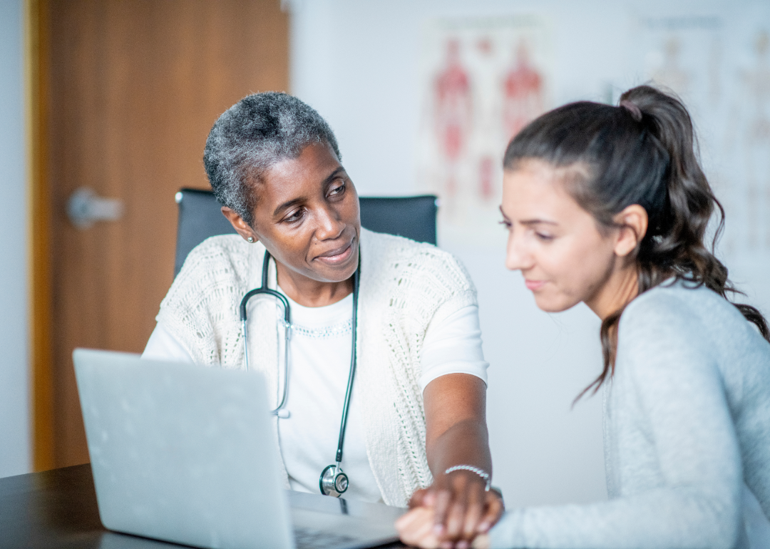 A doctor consults with a teen patient.