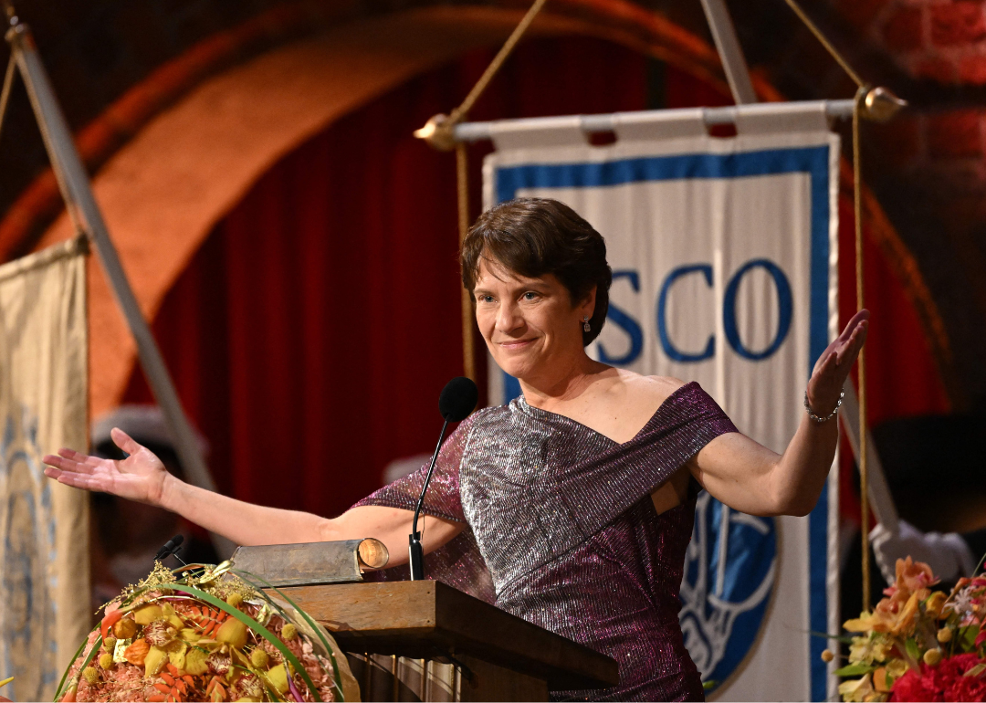 Image shows medium-closeup shot of Nobel Prize in chemistry winner Carol Bertozzi speaking from a podium