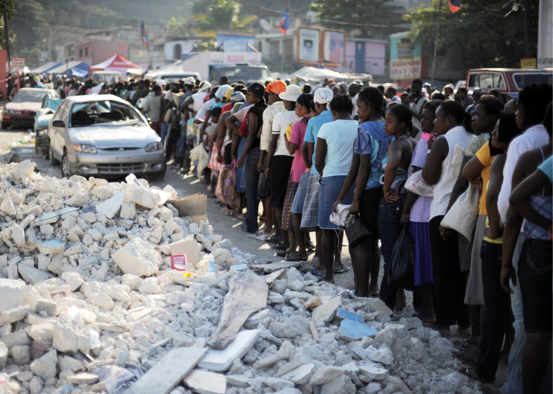 Haitians stand in line at a food distribution point in Port-Au-Prince.