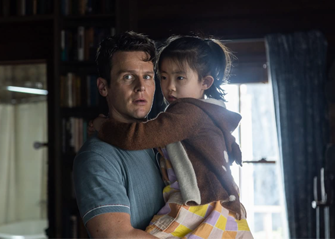 Jonathan Groff and Kristen Cui embracing one another in Knock at the Cabin.