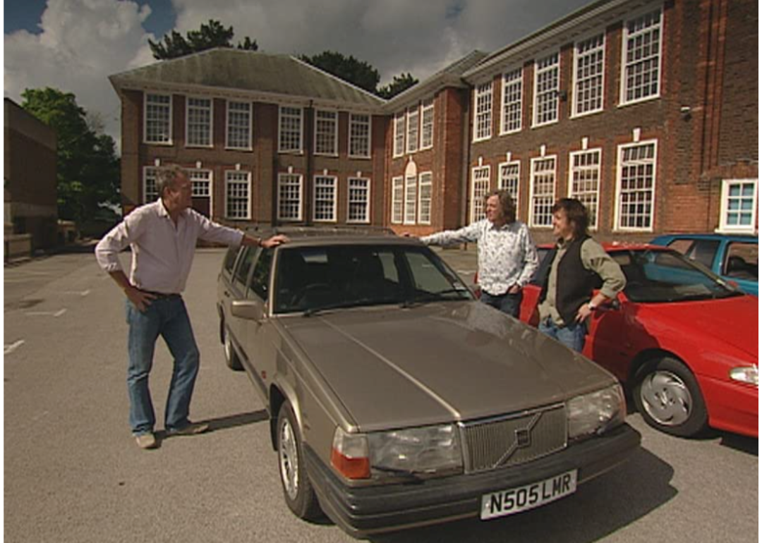 The cast of Top Gear inspects a car.