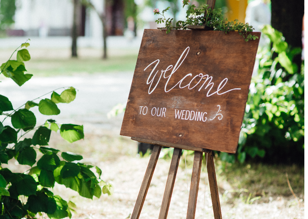A wooden sign reading "Welcome to our wedding."