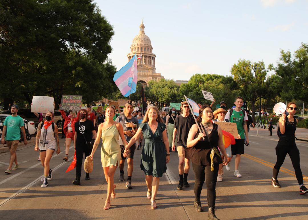 Photo shows people marching for abortion rights, holding signs