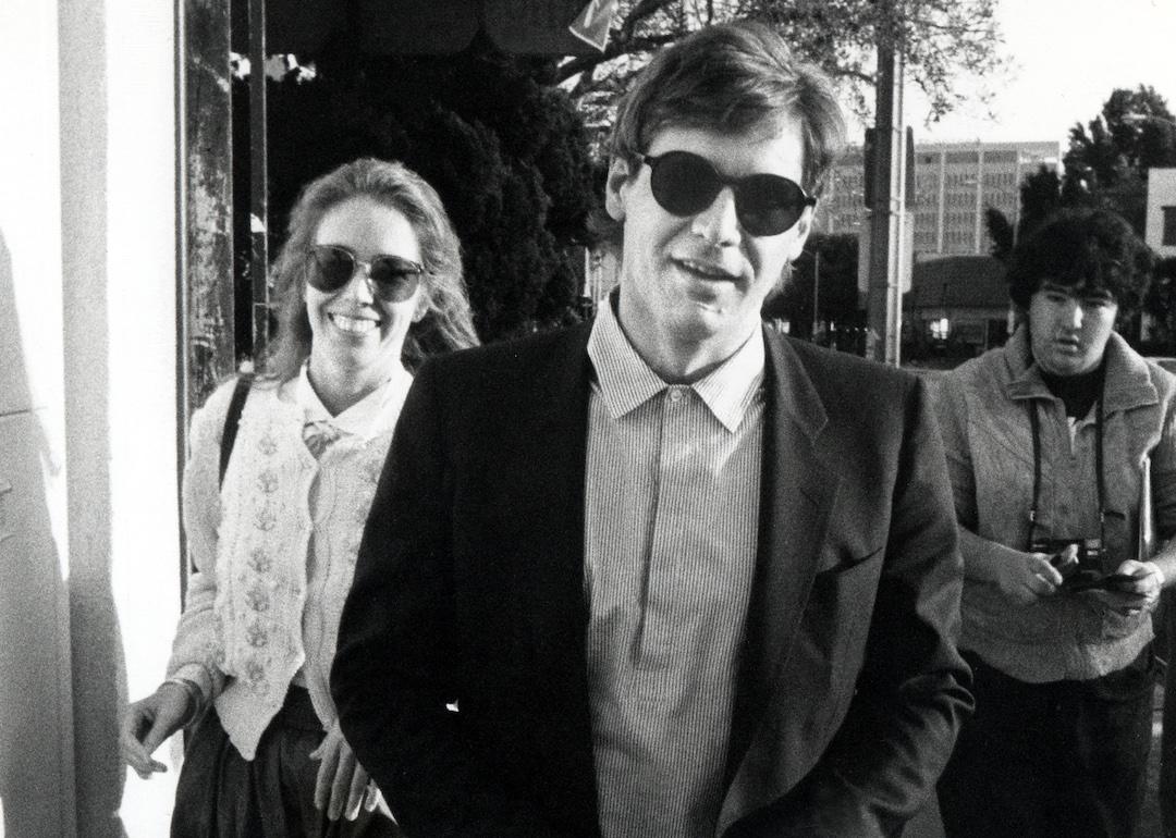 Harrison Ford and second wife, Melissa Mathison, walk down the street in sunglasses in 1983.