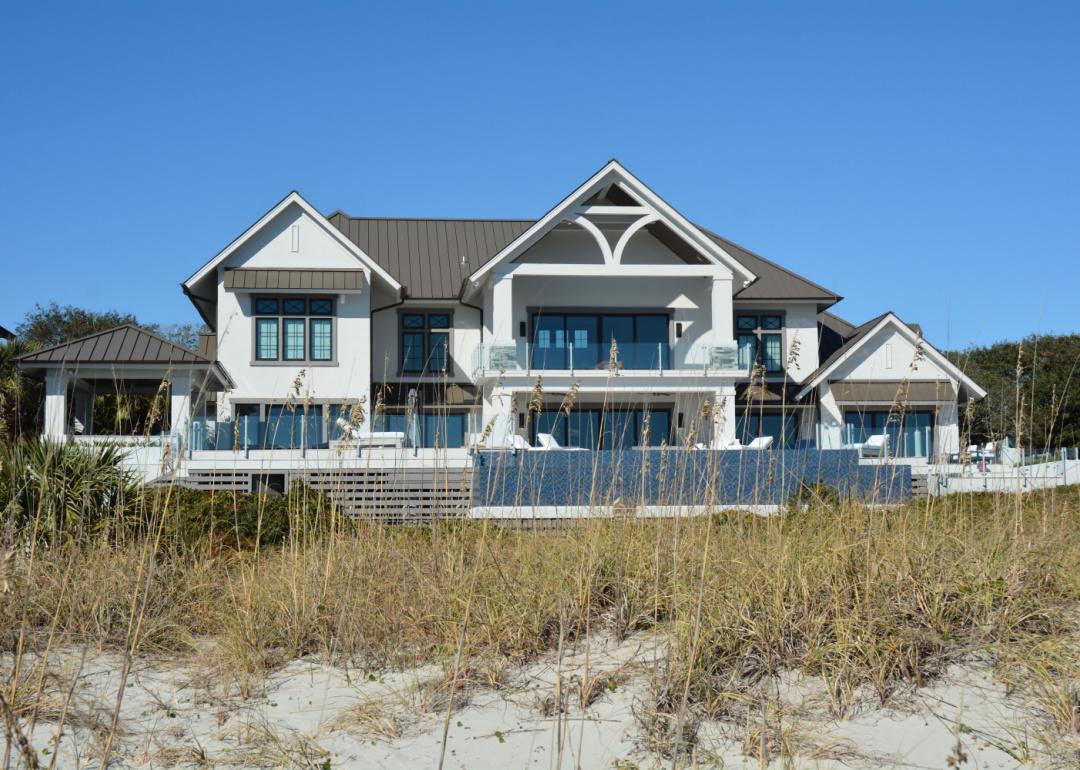 A large beach mansion photographed through the dunes in Myrtle Beach, South Carolina.