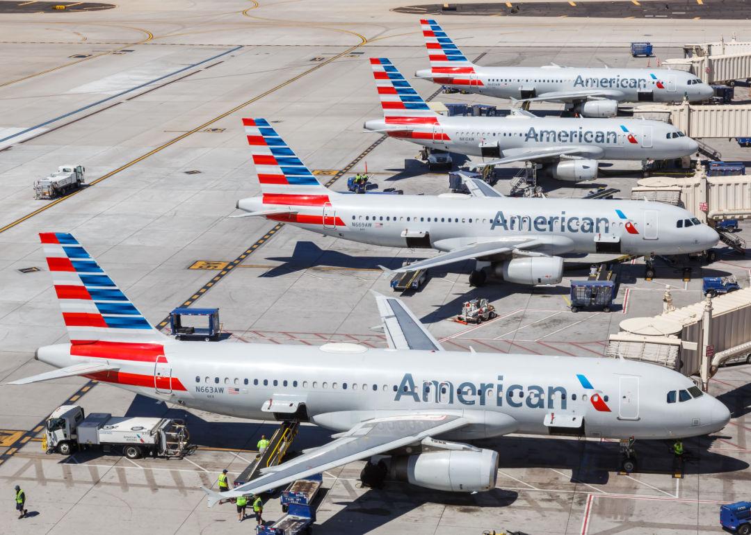 Four American Airlines jets parked at a terminal.