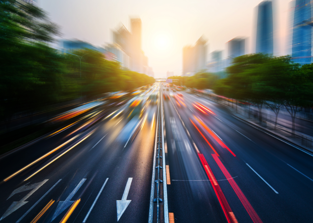 A blurred view of cars in motion driving along a freeway.