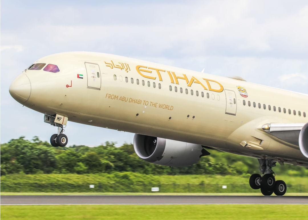An Etihad Airways plane lifts off the runway.