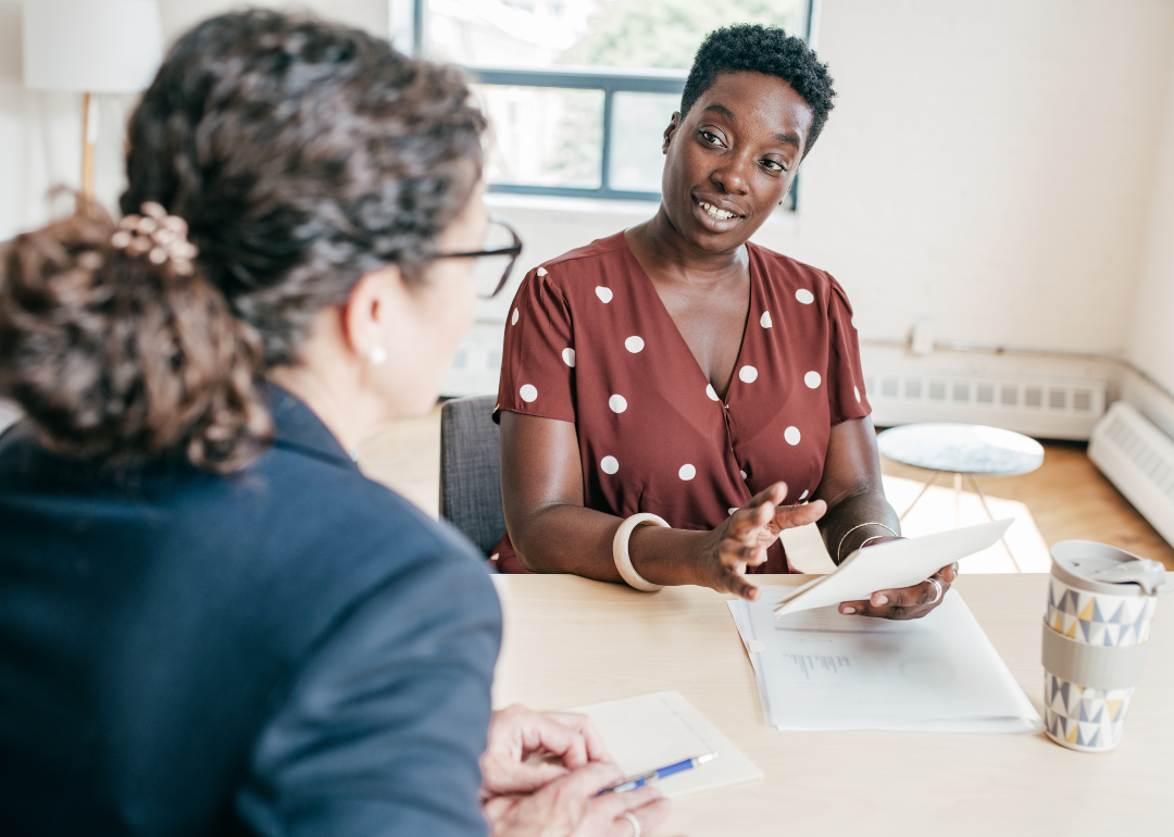 Two women in a meeting discuss hiring.