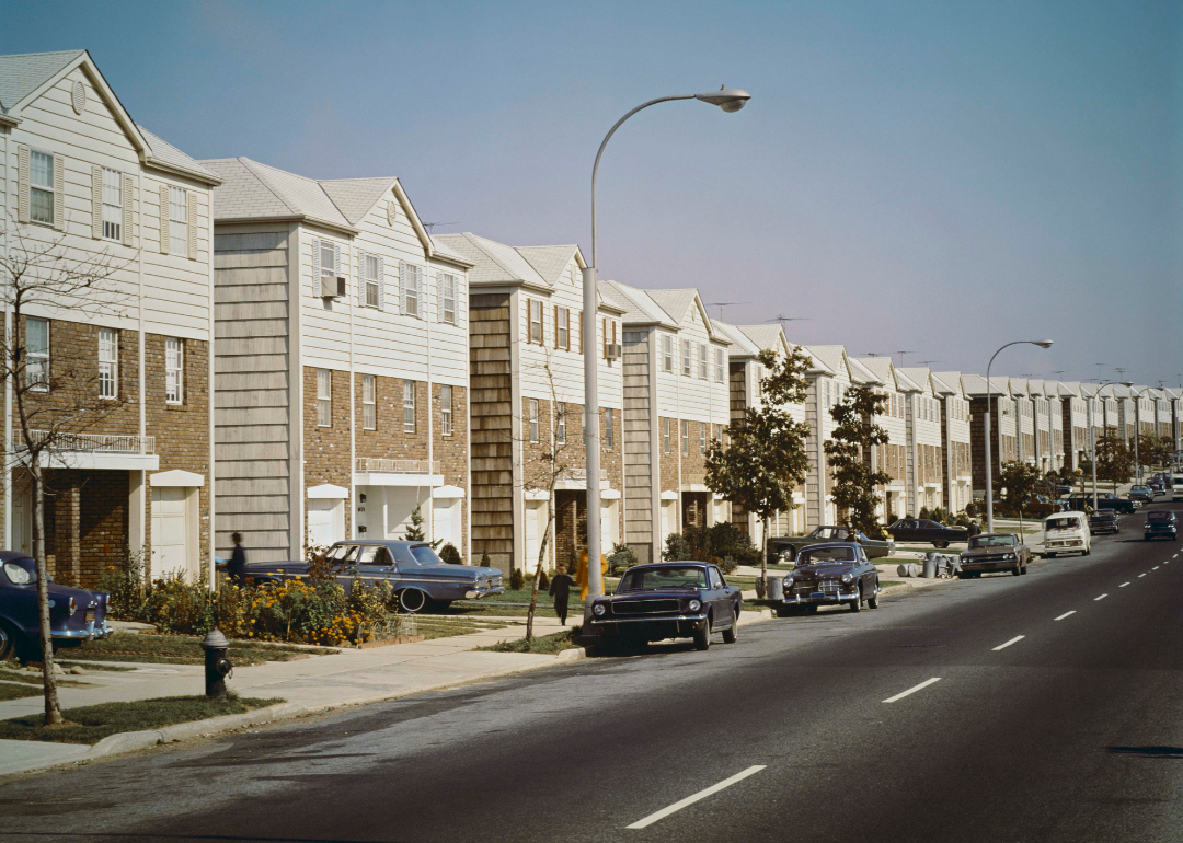 A street with a row of identical houses in 1965.