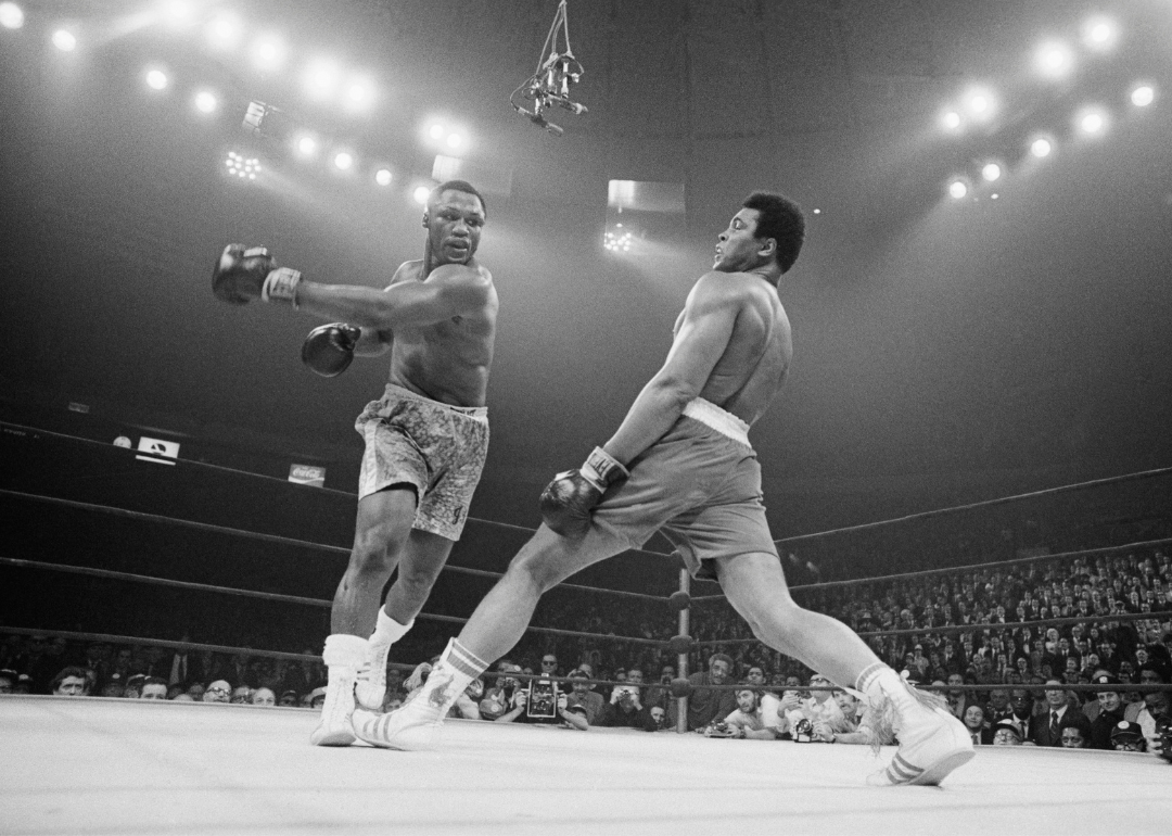 Muhammad Ali steps away from a punch thrown by boxer Joe Frazier during their heavyweight title fight at Madison Square Garden in 1971. 