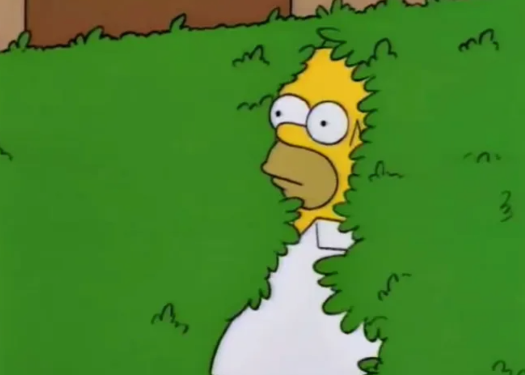 Homer Simpson backing in to the bushes.