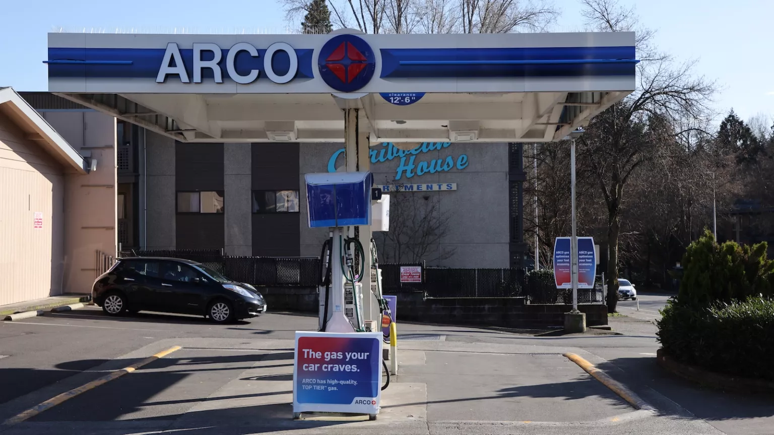 A car is parked at a gas station.