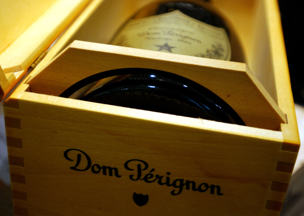 Closeup of a bottle of Dom Perignon in a wooden box.