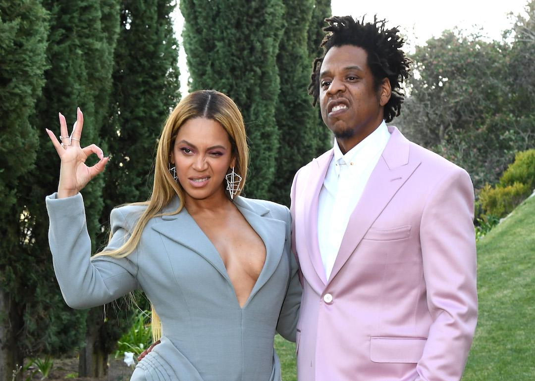 Jay-Z posing beside wife Beyonce on open lawn in 2020.