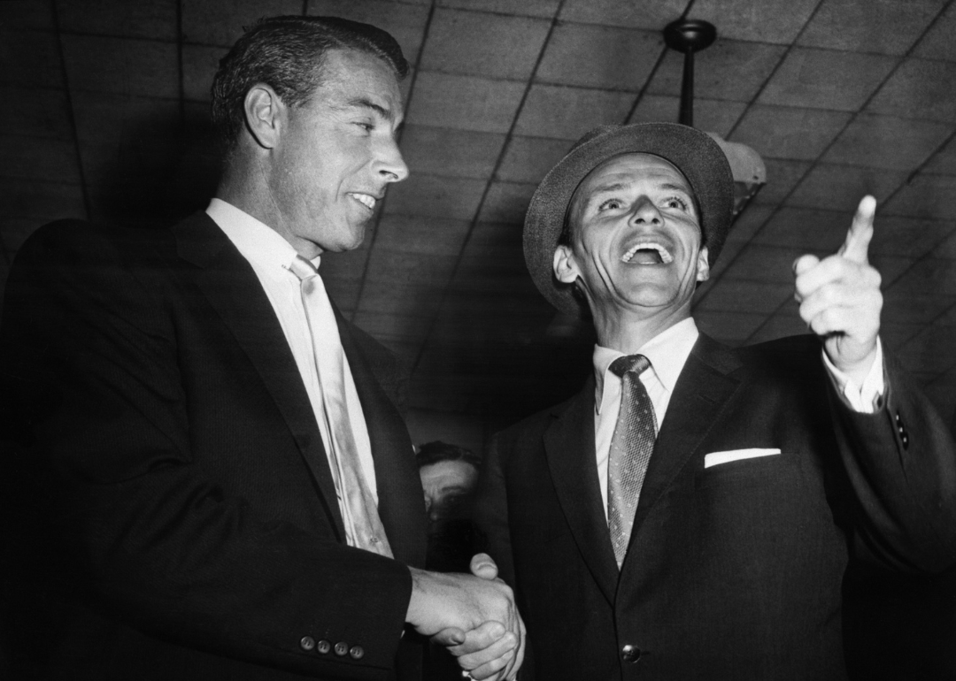 Frank Sinatra is greeted by Joe DiMaggio on his arrival at Idlewild Airport.