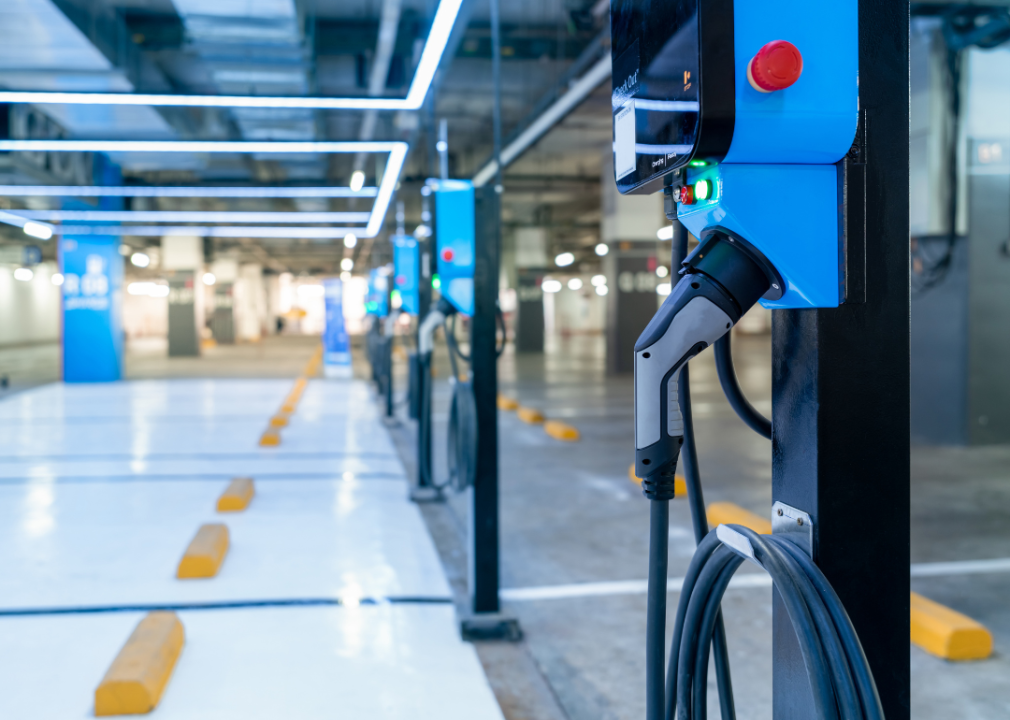 A row of electric vehicle charging stations in a parking garage