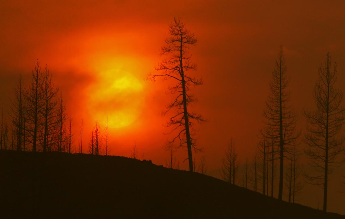 Smoke obscures the sun as it sets on the burn zone of the McKinley fire near Yreka, California, on August 1, 2022.