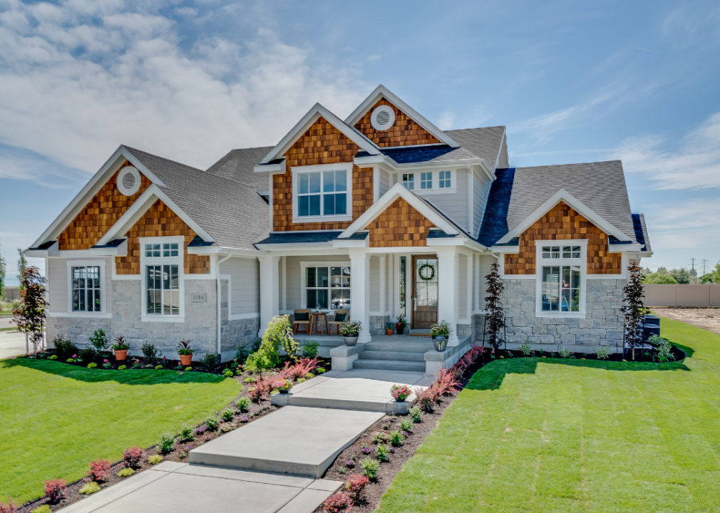 A large home centered in a green lawnscape