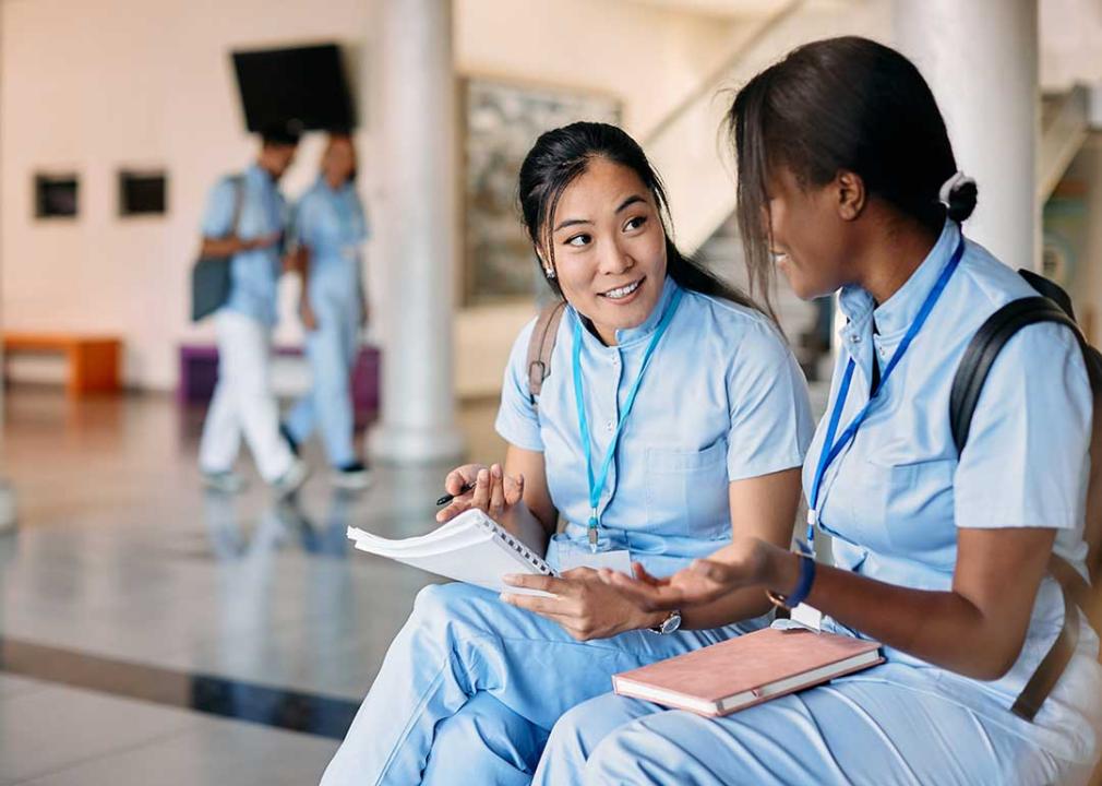 two nursing students have a discussion in a school setting