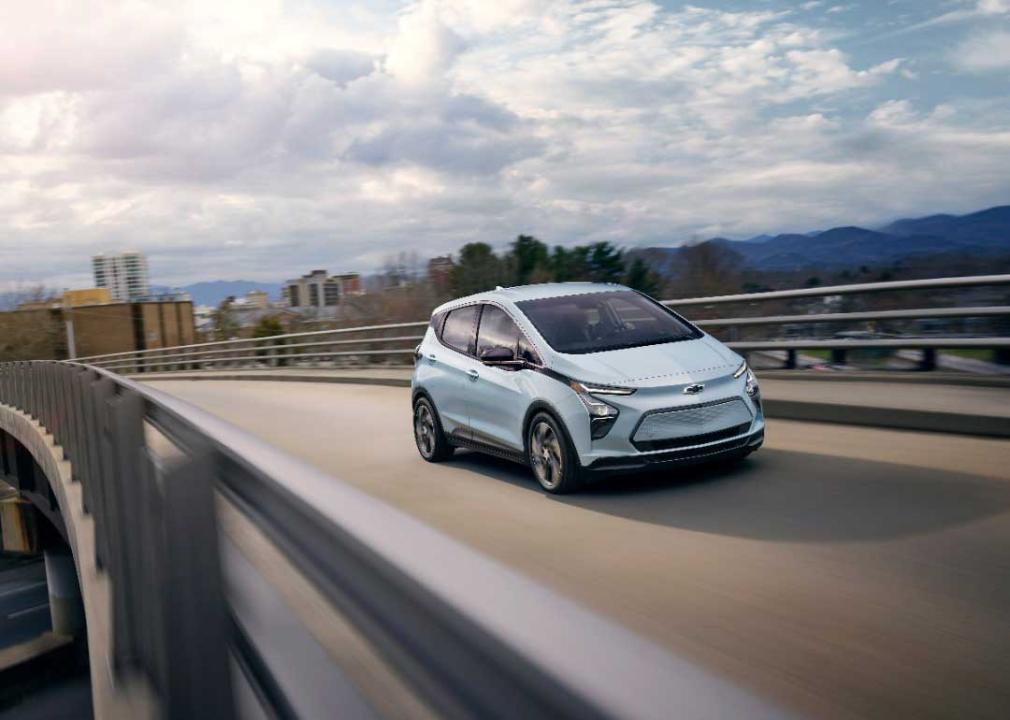 light blue chevy bolt driving