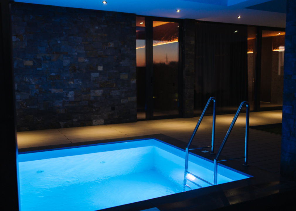 A plunge pool filled with cold water is illuminated at night.