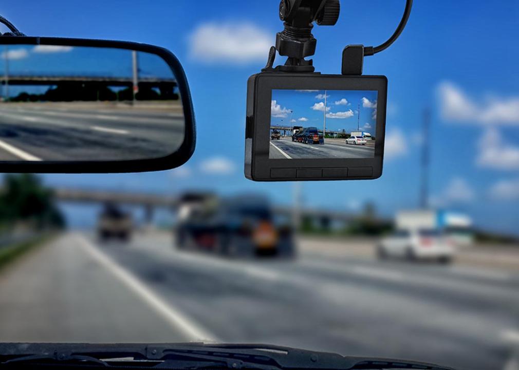 dash cam in focus showing road and sky with blurred scene in windshield
