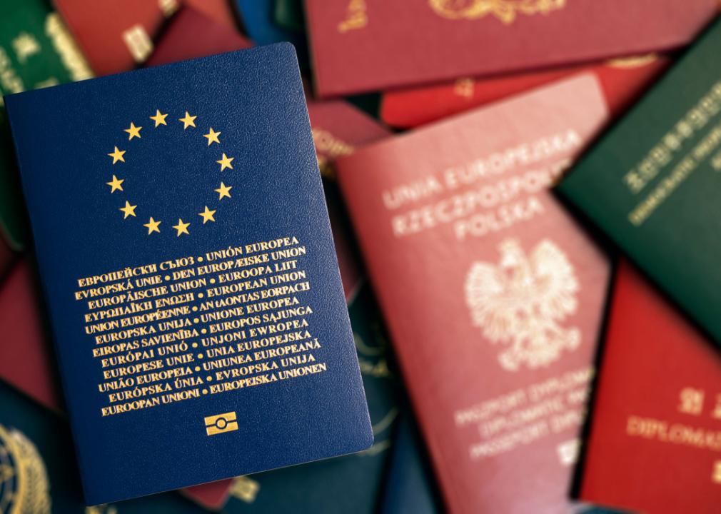 European Union blue biometric passport on background of passports of different countries