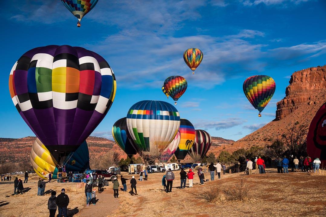 Spectators gather in open fields at the 'Balloons and Tunes' Festival in Kanab, UT