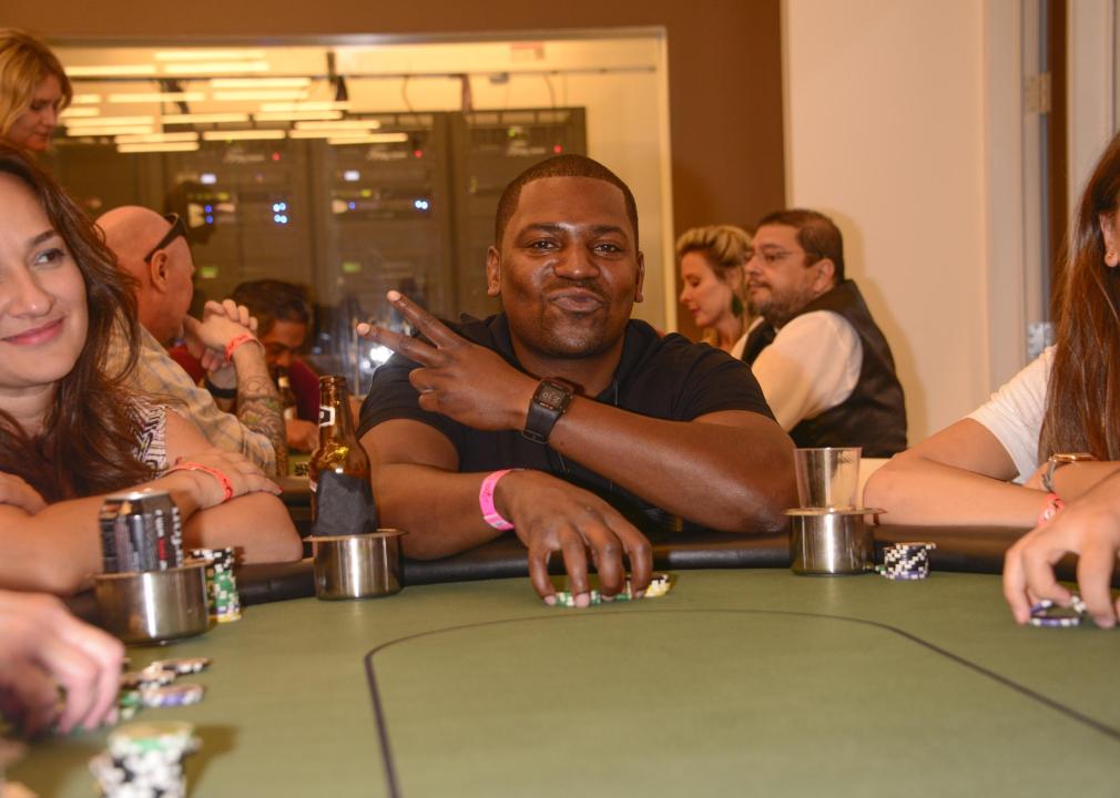 Mekhi Phifer giving the peace sign at a poker table.