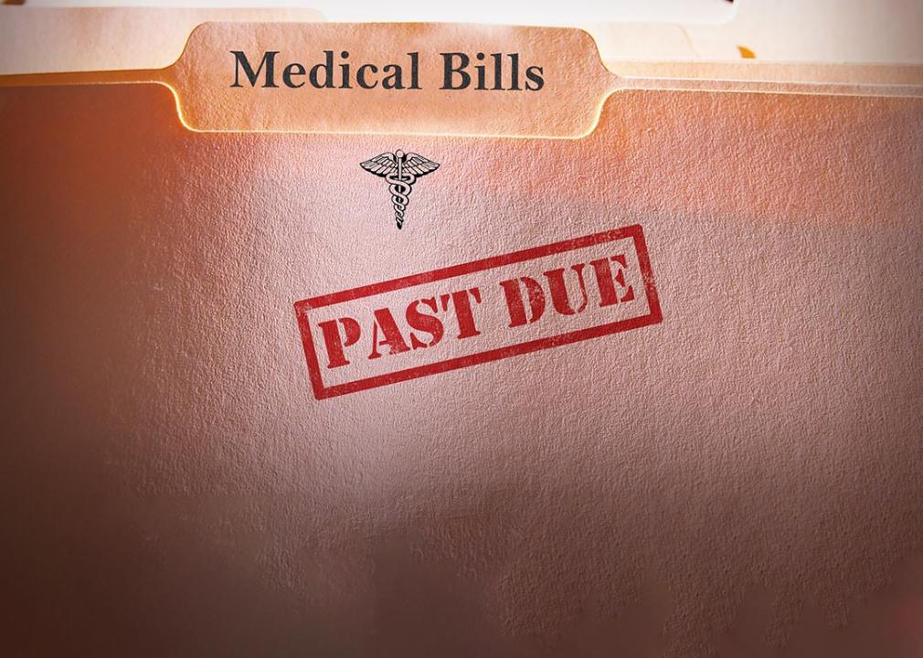 File folders of medical bills stamped with past due label